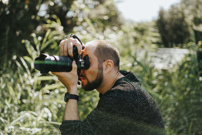 Portrait of young man photographing camera