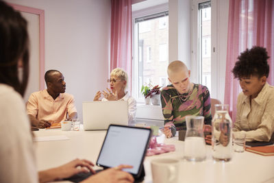 Coworkers sitting at business meeting in meeting room