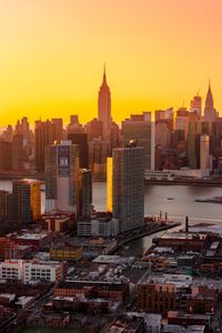 Aerial view of buildings in city during sunset