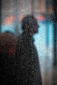 Shadow of person on wet window