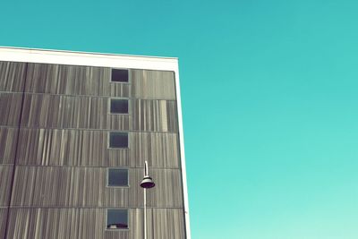 Low angle view of buildings against clear blue sky