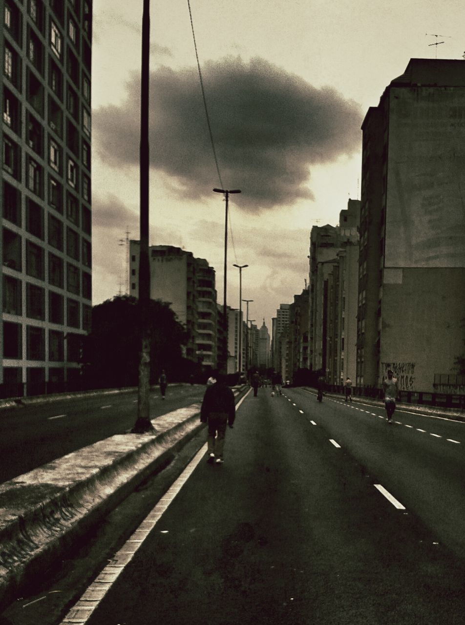 building exterior, architecture, built structure, city, transportation, street, sky, road, the way forward, men, walking, cloud - sky, city life, building, car, land vehicle, lifestyles, road marking