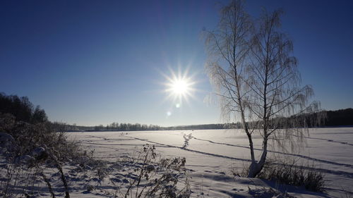 Scenic view of snow covered landscape against clear sky