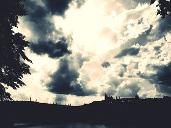 Low angle view of silhouette buildings against dramatic sky