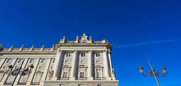 Low angle view of building against blue sky