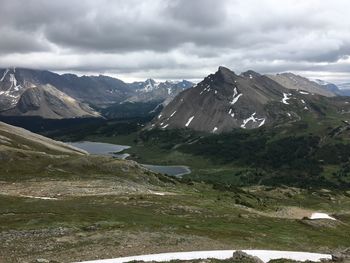 Scenic view of mountains against cloudy sky