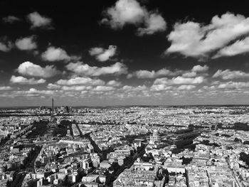 High angle view of cityscape against cloudy sky