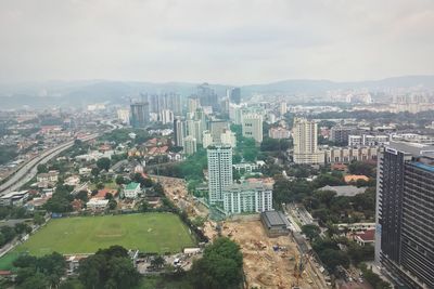 High angle view of buildings in city against sky