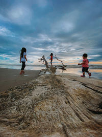 People on beach against sky