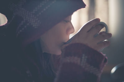 Close-up of young woman wearing hat