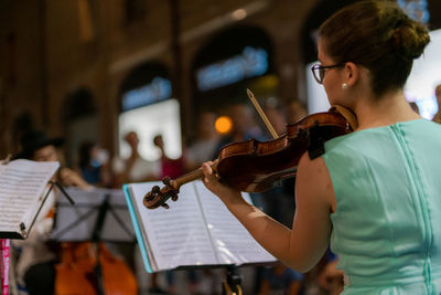 Midsection of woman playing in the concert