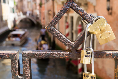 Close-up of padlocks on railing