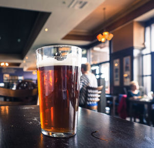 Close-up of beer glass on table