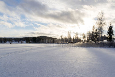 Snow covered landscape against sky