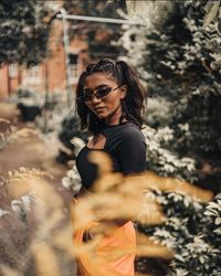 Young woman wearing sunglasses standing outdoors