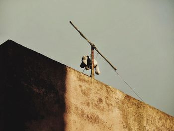 Low angle view of man hanging against wall