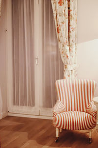 Empty armchair against window at home