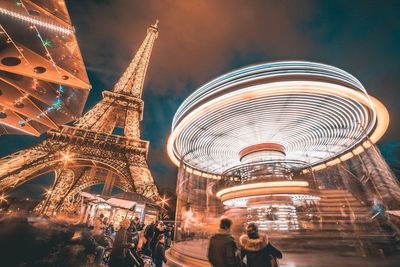 Low angle view of illuminated ferris wheel at night