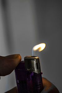 Close-up of hand holding candle