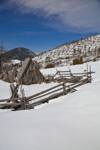 Snow covered landscape against sky