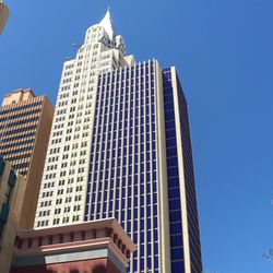 Low angle view of modern building against clear blue sky