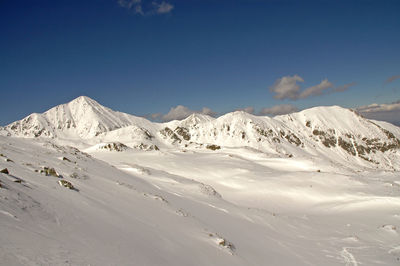 Snow covered mountain ridge and slopes, retezat mountains, southern carpathians, romania