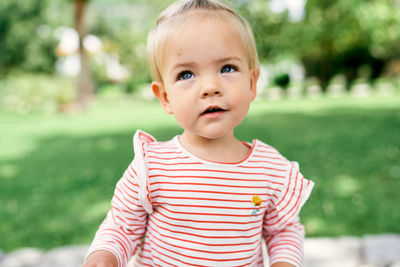 Portrait of cute boy standing outdoors