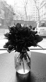 Close-up of flower vase on table in city