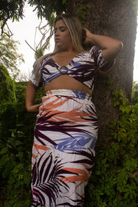 Midsection of woman against trees