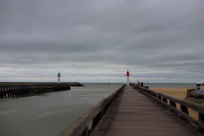 Pier over sea against sky