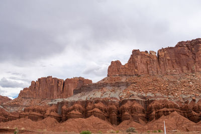 Capitol reef national park low angle landscape of pink, orange and purple barren stone hillside 