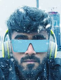 Close-up portrait of man in snow
