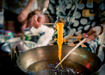 Midsection of man preparing food