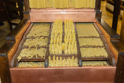 Pasta variety in wooden compartmented box, variety of uncooked pasta.