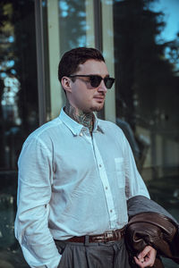 Young man wearing sunglasses standing outdoors