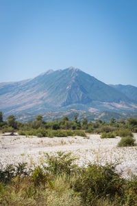 Scenic view of mountains against clear blue sky