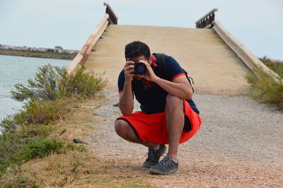 Side view of man photographing