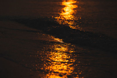 Close-up of sea against sky at sunset