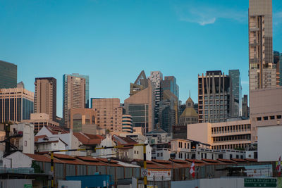 Buildings in city against clear sky
