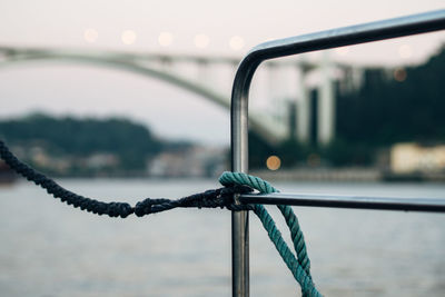 Close-up of rope on railing by douro river