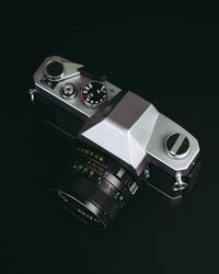 High angle view of camera on table against black background