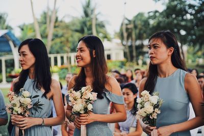 Women standing by flowering plants