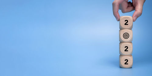 Close-up of human hand against blue background