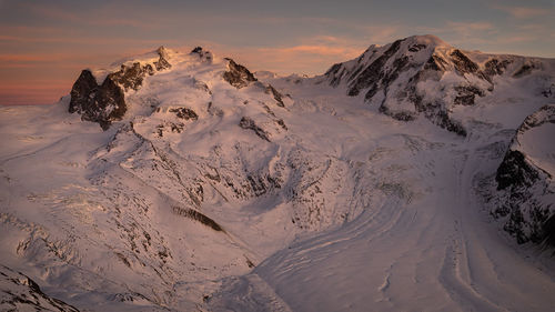 Scenic view of snow covered mountains against sky