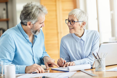 Smiling business people discussing