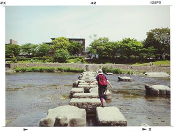 Full length of woman standing on tree trunk