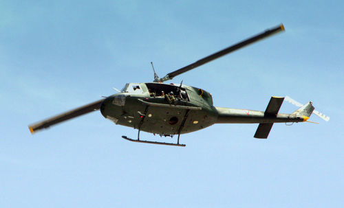 Low angle view of helicopter against sky