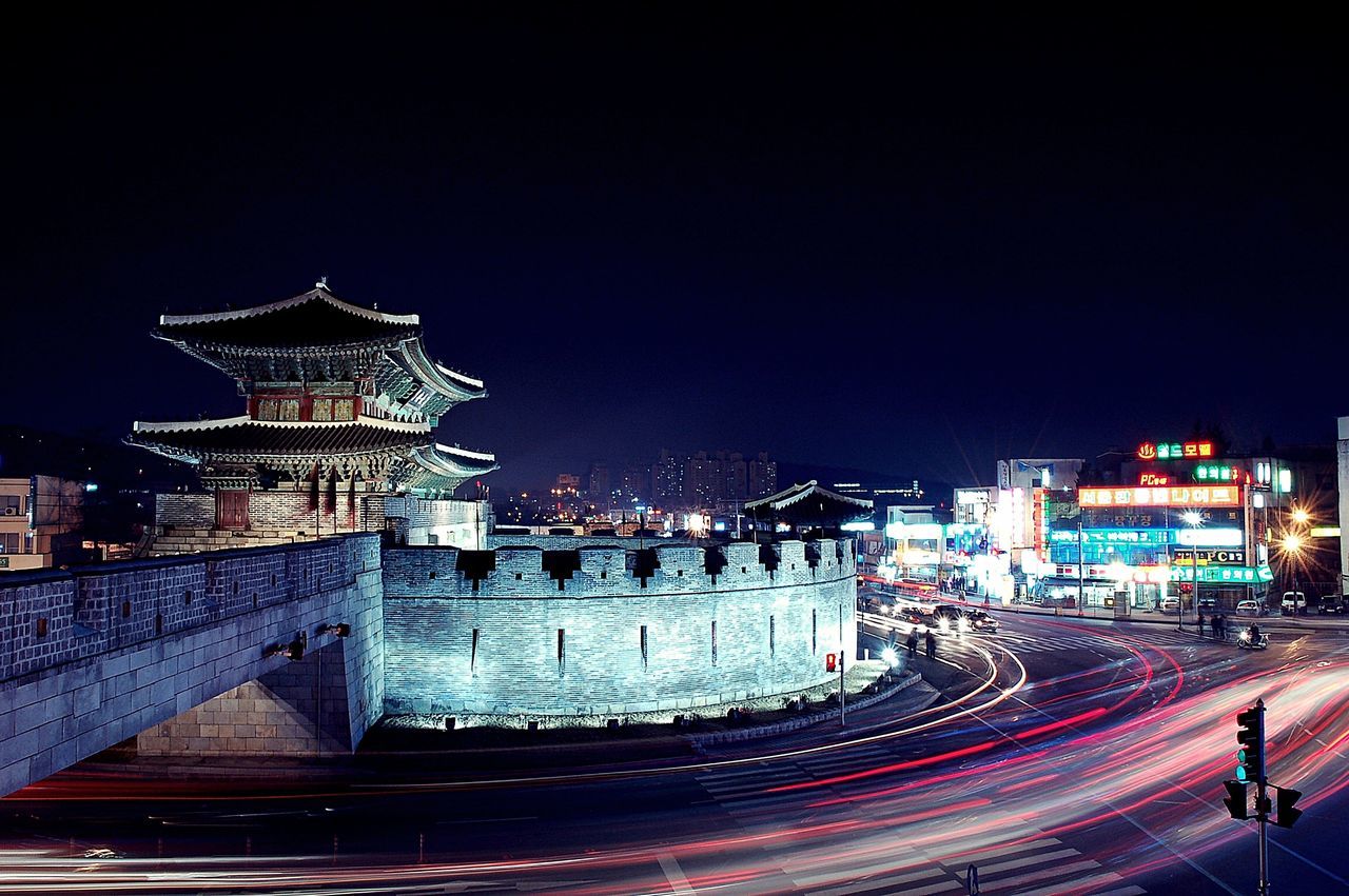 architecture, illuminated, night, building exterior, built structure, city, clear sky, copy space, travel destinations, high angle view, city life, cityscape, light trail, famous place, travel, road, outdoors, sky, no people, capital cities