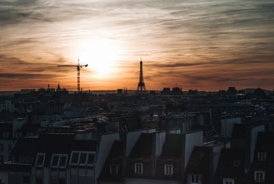 Buildings in city during sunset