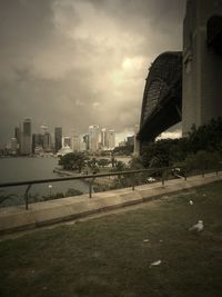 Buildings in city against cloudy sky